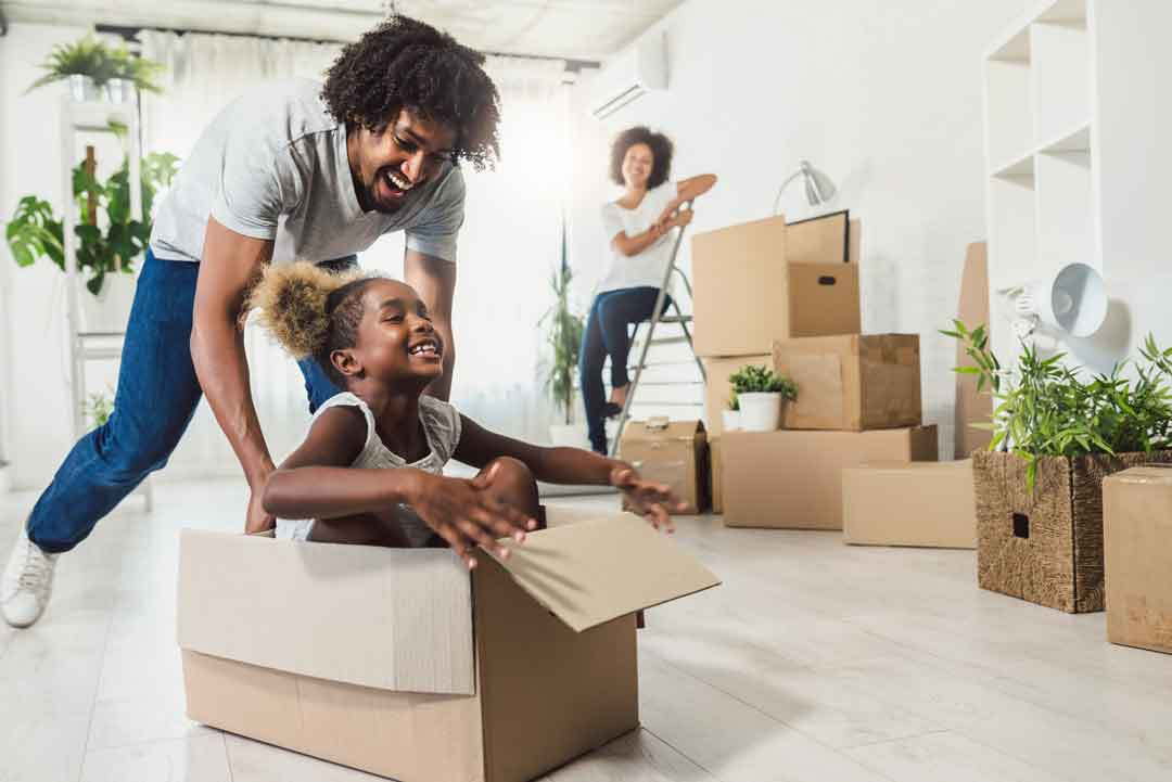family having fun as they move in to their new house
